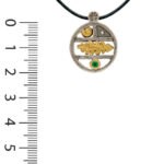 Pendentif en argent, rond en forme d'étagère sur laquelle sont disposés des motifs en or coquillage et feuille ainsi qu'une emeraude